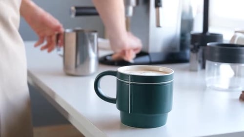 Adult Prepares Coffee Using Espresso Machine in Kitchen