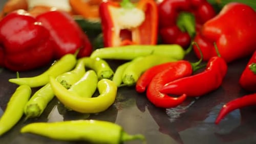 Fresh Peppers on Dark Reflective Surface