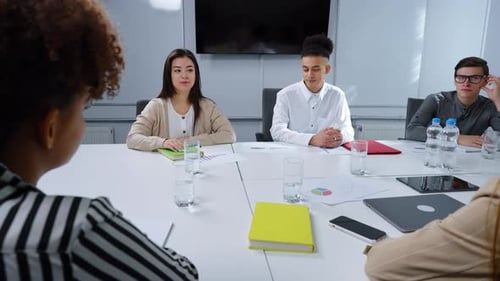 Young Adults Having a Meeting at Conference Table