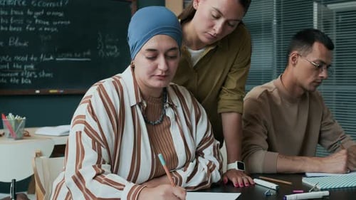 Adult Students Learning Together in Classroom with Teacher