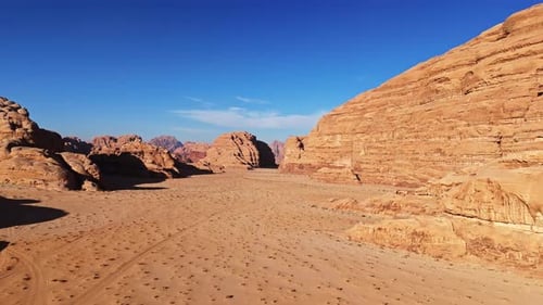 Cinematic aerial flight through a red desert valley in Jordan