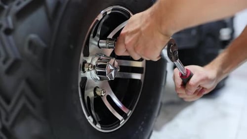 Replacing the Wheel of the ATV in the Store Before the Sale