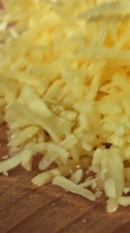 Grated Cheese Falls on a Wooden Board Filmed on a Highspeed Camera at 1000 Fps