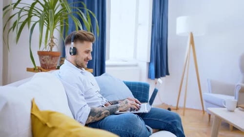 Man working from home on sofa during lockdown video call concept