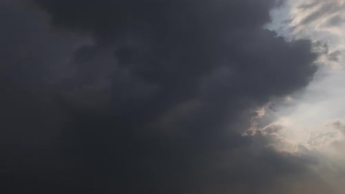 Zeitraffer eines isolierten Himmels am späten Nachmittag, der Licht und Dunkelheit kontrastiert. Sturmwolken und Sonne erzeugen vo
