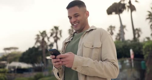 Young Adult Using Phone with Palm Trees