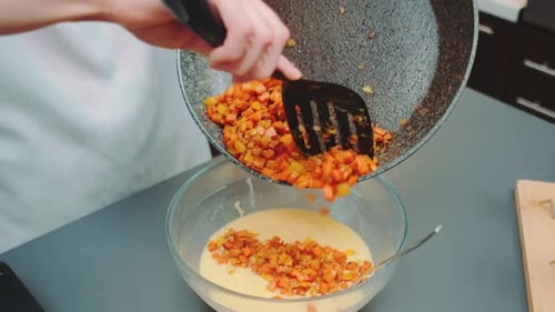 Diced Vegetables Poured into Bowl of Batter