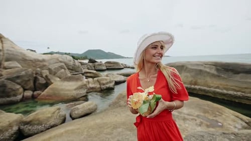 Romantic Woman with Cocktail on Rocky Shore Slow Motion