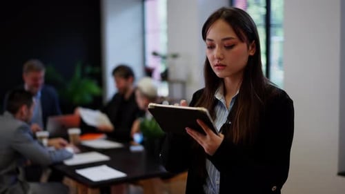 Concept of Successful Businesswoman Browsing Tablet in Office Young Woman Working Administrator