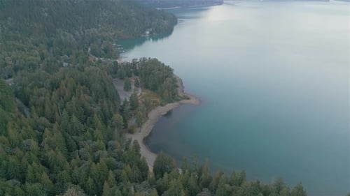 Aerial View of Lake and Green Trees in Forest Around Mountain Landscape