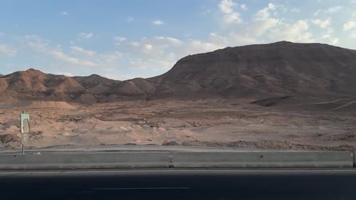 A view of a Mountain in desert from a car on high way, trucking shot