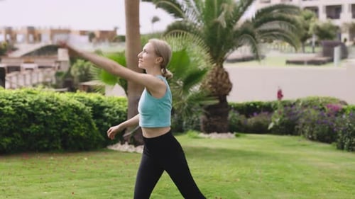 Une jeune femme fait des exercices d'étirement à l'extérieur La femme blonde la suit avec diligence au quotidien