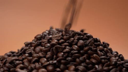 Pouring Dark Roasted Coffee Beans Close Up