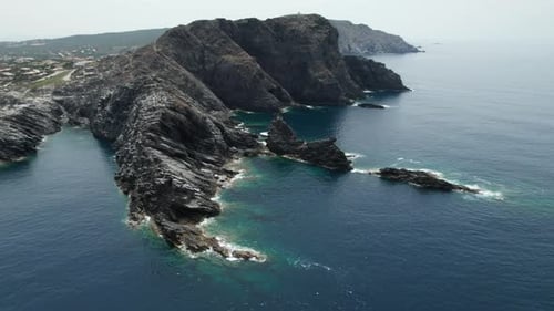 Aerial view fly over drone over sea cliff with powerful sea waves. Beach sand in Sardinia, Italy, Pe