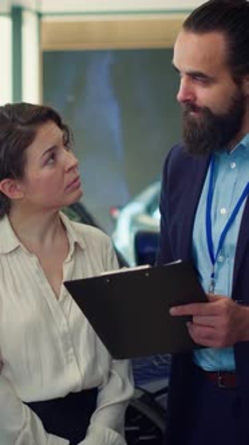 Vertical Video Portrait of Happy Salesman Talking with Clients Showcasing Dealership Vehicle