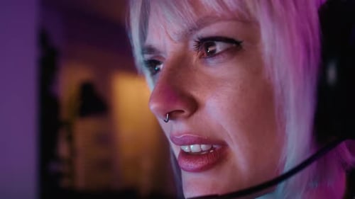 Close up of young caucasian woman playing game at night on Desktop PC. Shot with RED helium camera i