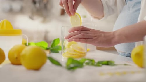 Preparing Lemon Drink at Kitchen Counter