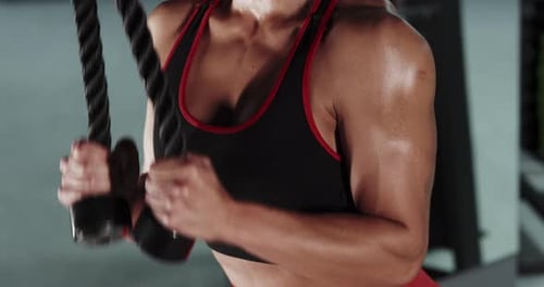 Athletic Woman Bodybuilder Doing Exercises in the Gym