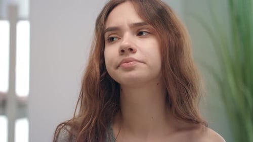 Sick woman using nasal spray for congestion relief