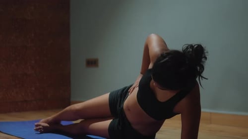 Woman Doing Side Plank Exercise on Yoga Mat