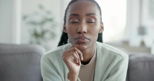 Black woman, thinking of future and relax on couch with dream, memory or remember