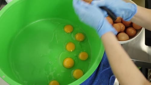 Eggs Cracking in Bowl with Knife and Gloves