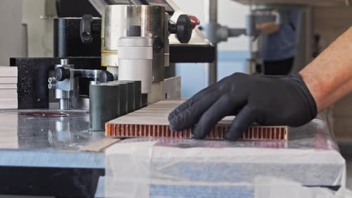 Closeup View of Male Hands Gloved Working with Furniture and Adhesive in a Factory Setting