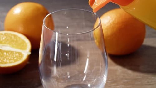 Fresh Orange Juice Poured into Glass Indoors
