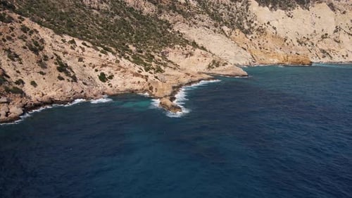 Ibiza coastline approaching natural infinity pool aerial (Sa Pedrera de Cala d'Hort)