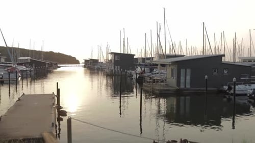 walking by a small little harbour whole sunrise with houseboats