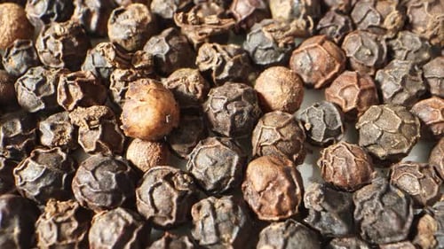 Pile of Wrinkled Black Peppercorns Close Up