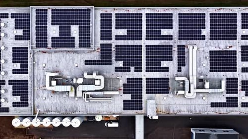 Aerial view of massive rooftop solar panel installation for renewable energy