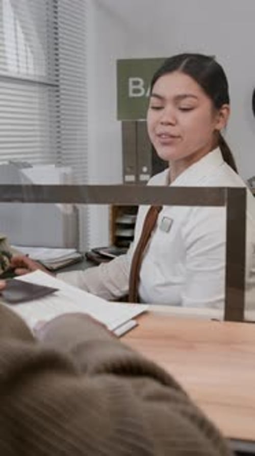 Bank Teller Helping Customer with Financial Transaction