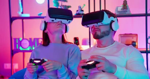 Couple Wearing VR Headsets and Playing Video Games