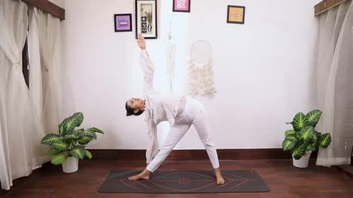 Video of woman performing Triokonasana(triangle pose)