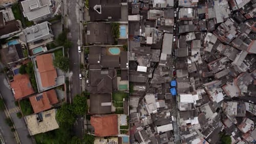 Flying parallel to an urban city line cutting the poor from the wealthy - Aerial view