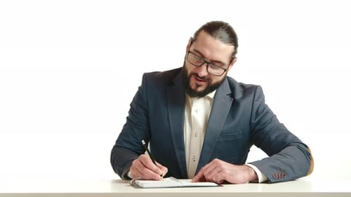 Professional Man Writing at Desk Talking