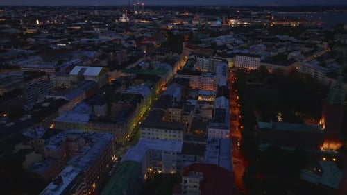High Angle View of Buildings and Streets in Urban Neighborhood Tilt Up Reveal of Evening Cityscape