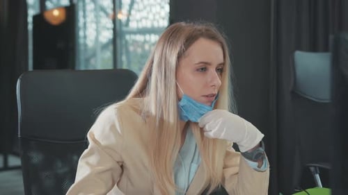 Office Professional Young Woman Working By Computer Moving Down Her Medical Mask to Breath Fresh Air