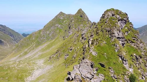 A Captivating Top-Down View of a Lush Mountain Valley, with Towering Peaks, Endless Blue Sky, and Sw