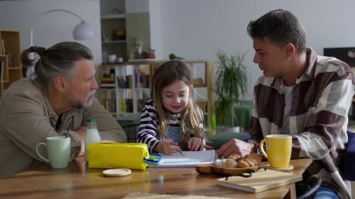 Girl Drawing with Father and Grandfather at Table