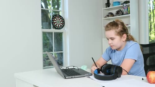 Diligent Girl Doing Homework at Desk