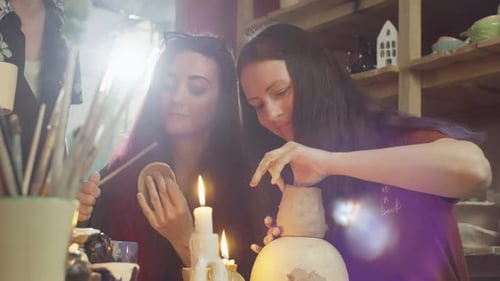 Women Creating Pottery Together in Brightly Lit Studio