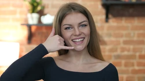 Woman Gestures Call Me with Smiling Face