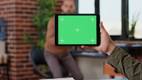 Holding Tablet with Chroma Key in an Office