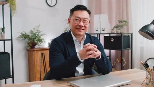 Asian Businessman Freelancer at Office Workplace Working on Laptop Computer Sends Online Messages