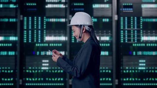 Asian Businesswoman Use Smartphone While Walking in Data Center