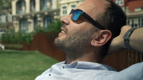 Young Man Relaxing in Park in City 30s