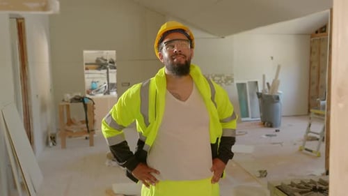 Construction Worker Inspects Building Renovation Progress