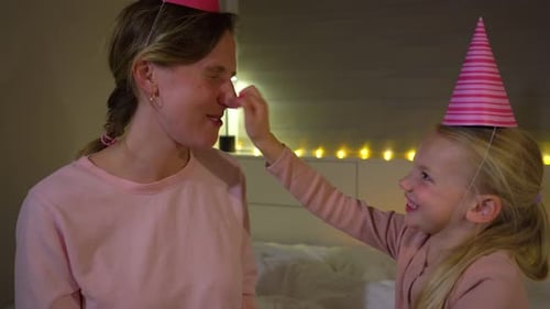 Joyful Girl and Adult Celebrating Birthday at Home